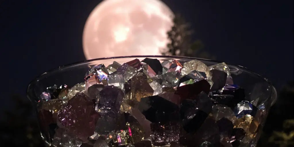 Crystals glowing beneath a pink Strawberry Moon outdoors