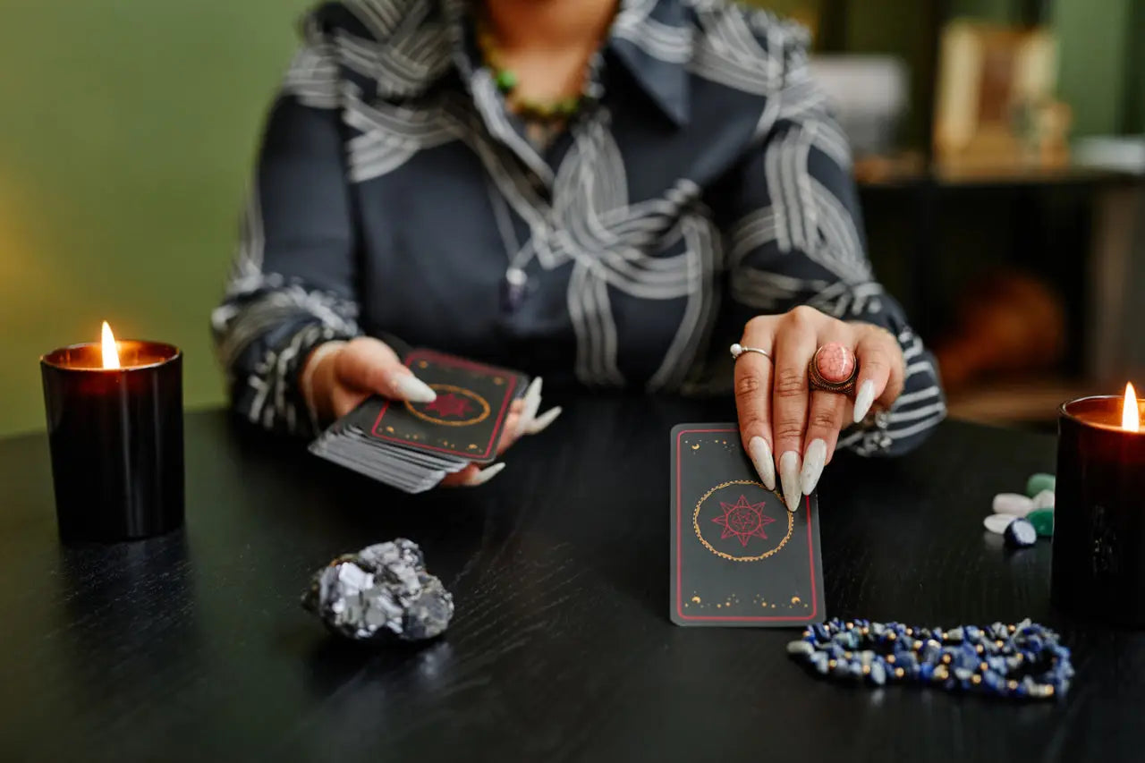 Tarot card reader consulting with client, examining cards depicting fear and uncertainty.