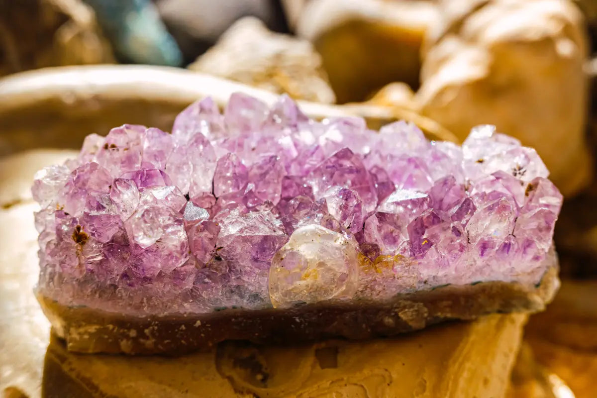 Amethyst geode on a table, showcasing its purple crystals for healing energy and spiritual properties.