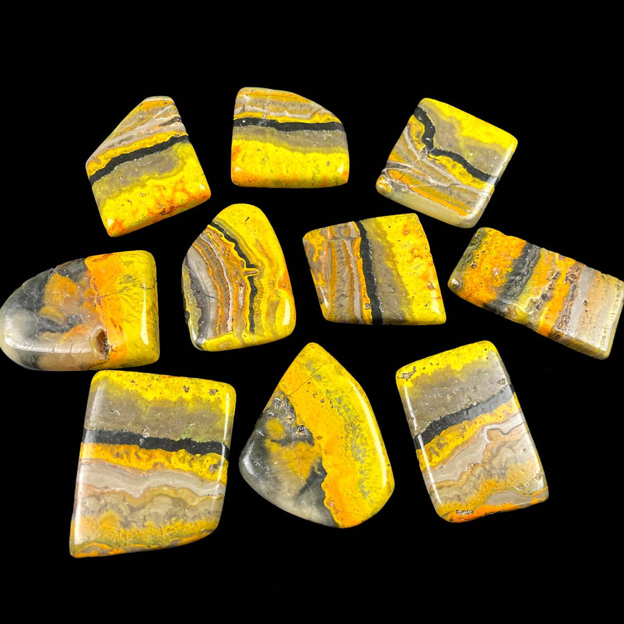 Polished yellow and gray Bumblebee Jasper stones in a cluster for Jumbo Bumblebee Jasper