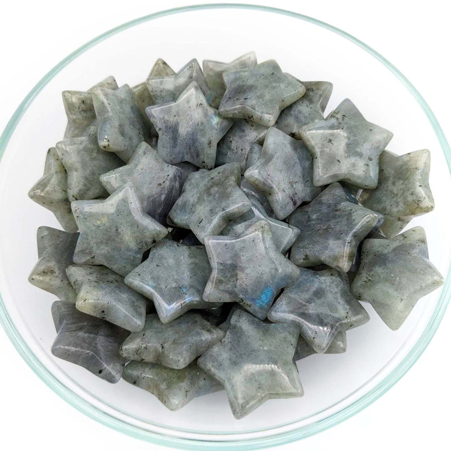 Star-shaped gray Labradorite mini star stones clustered in a decorative pile