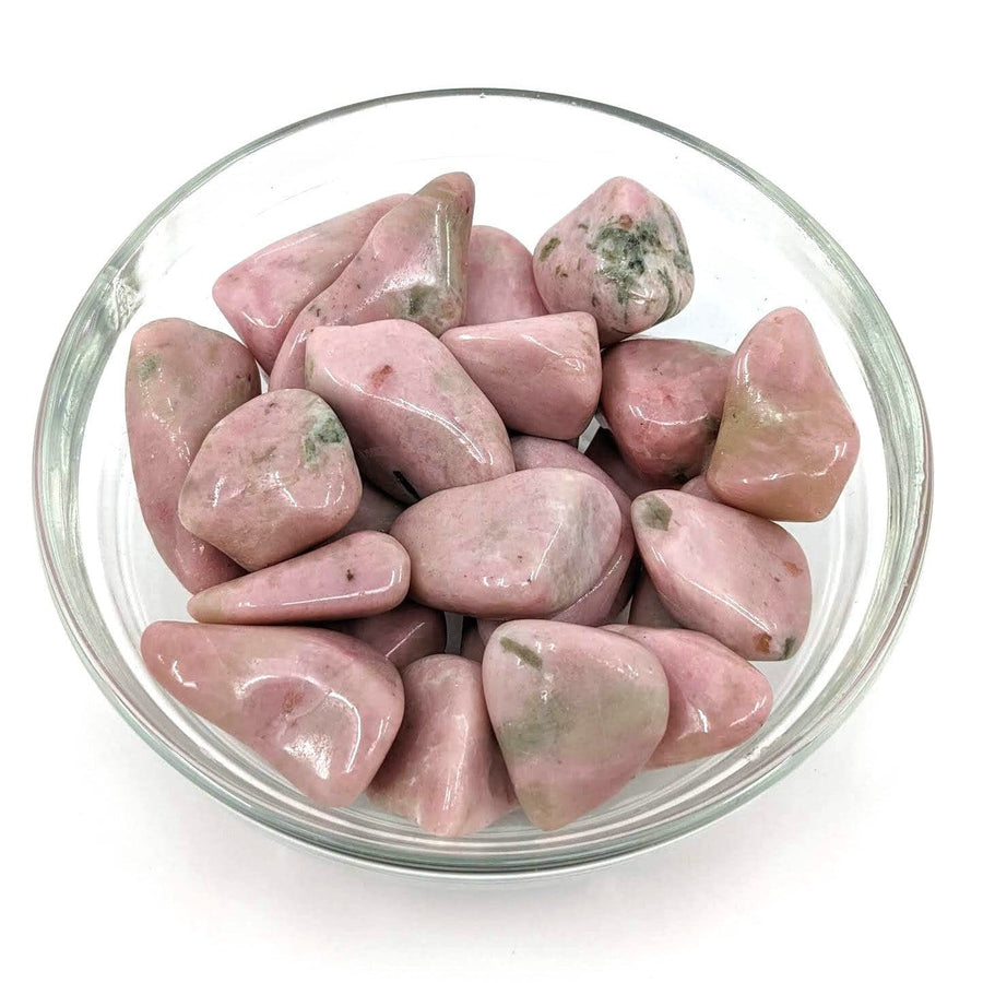 A bowl filled with beautiful clinozoisite tumbled stones, perfect for selection