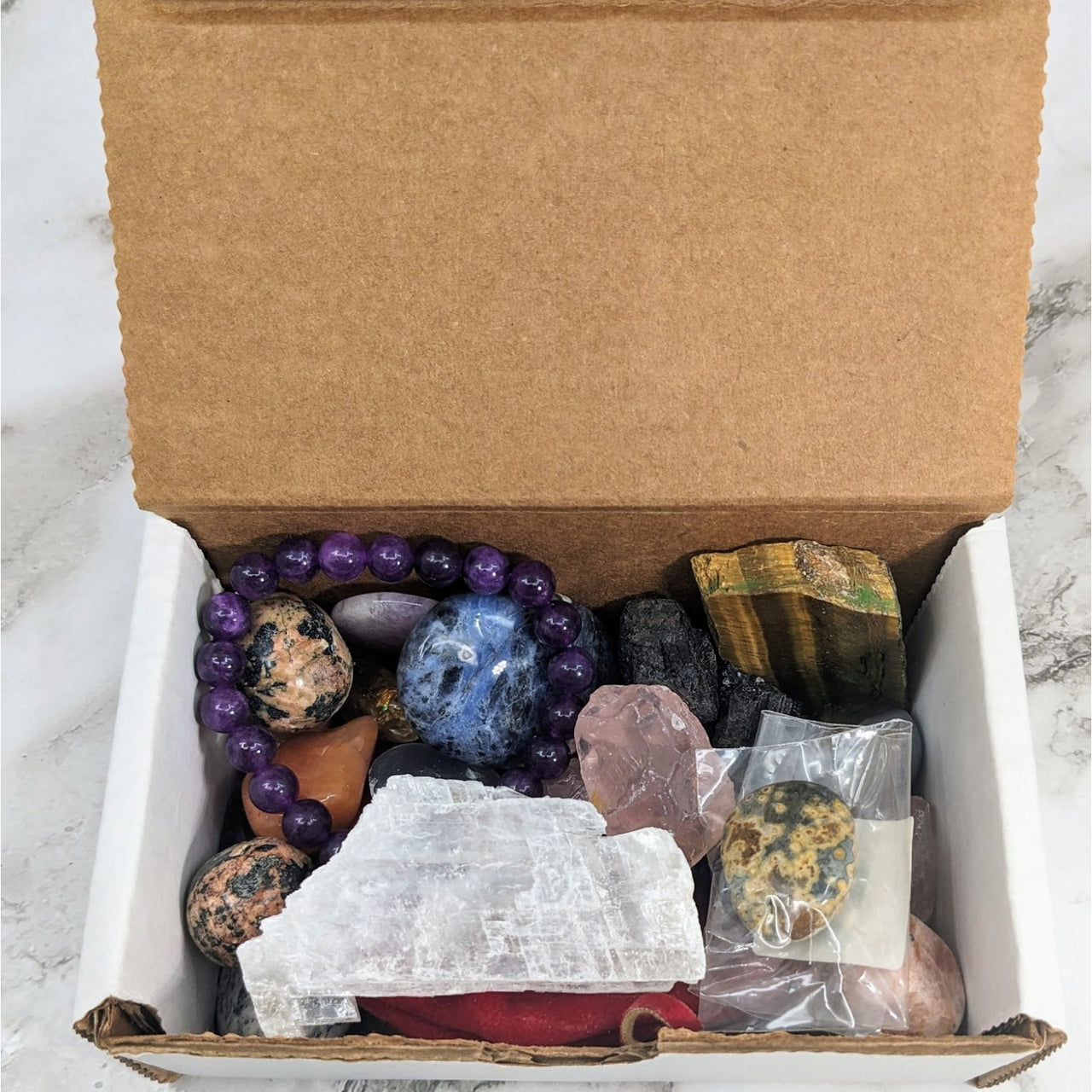 A treasure chest of rough stones and crystals from the 1 lb Treasure Box Mixed Stones pack