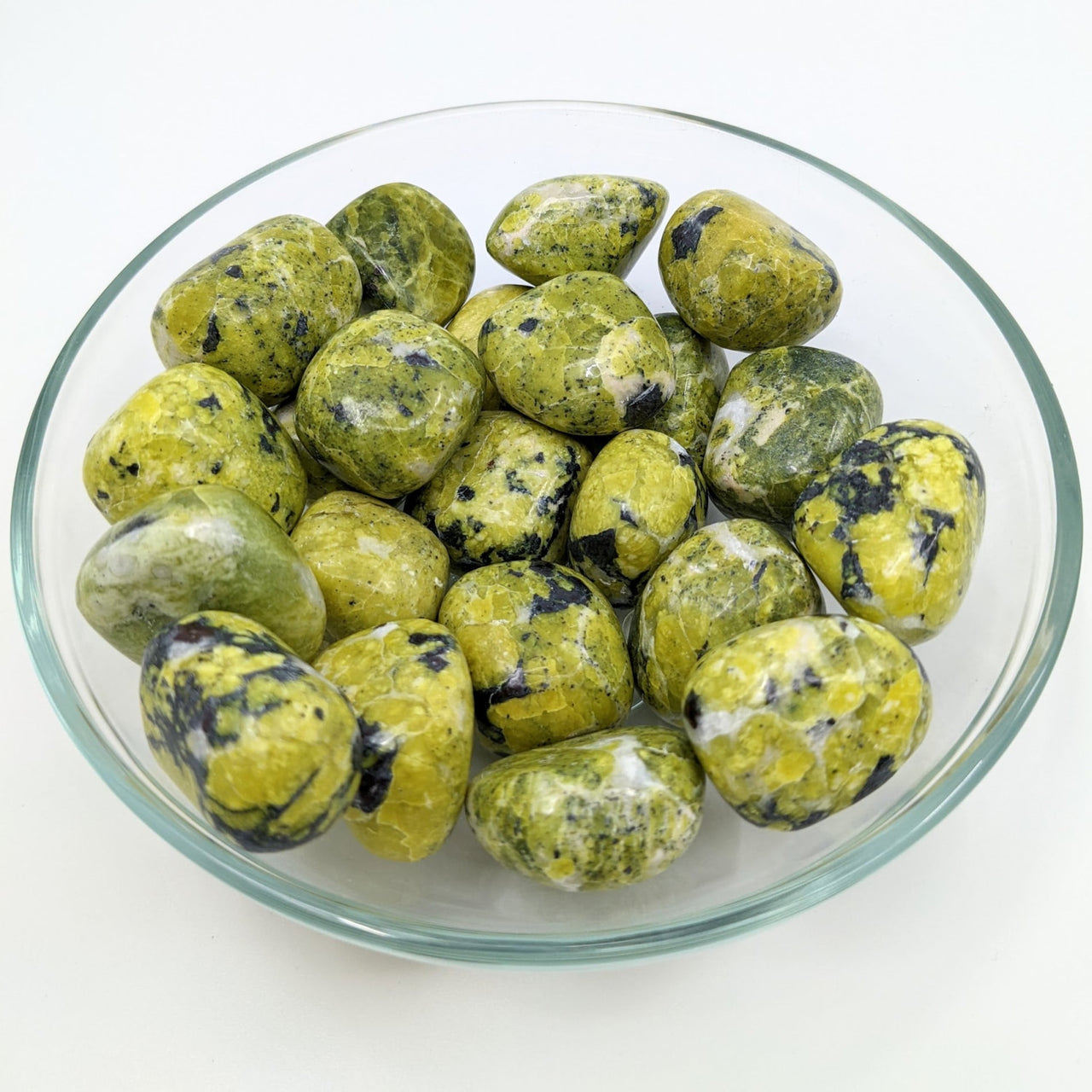 A bowl of green and blue tumbled stones from 1 Lizardite 1’ Serpentine Tumble #SK9163