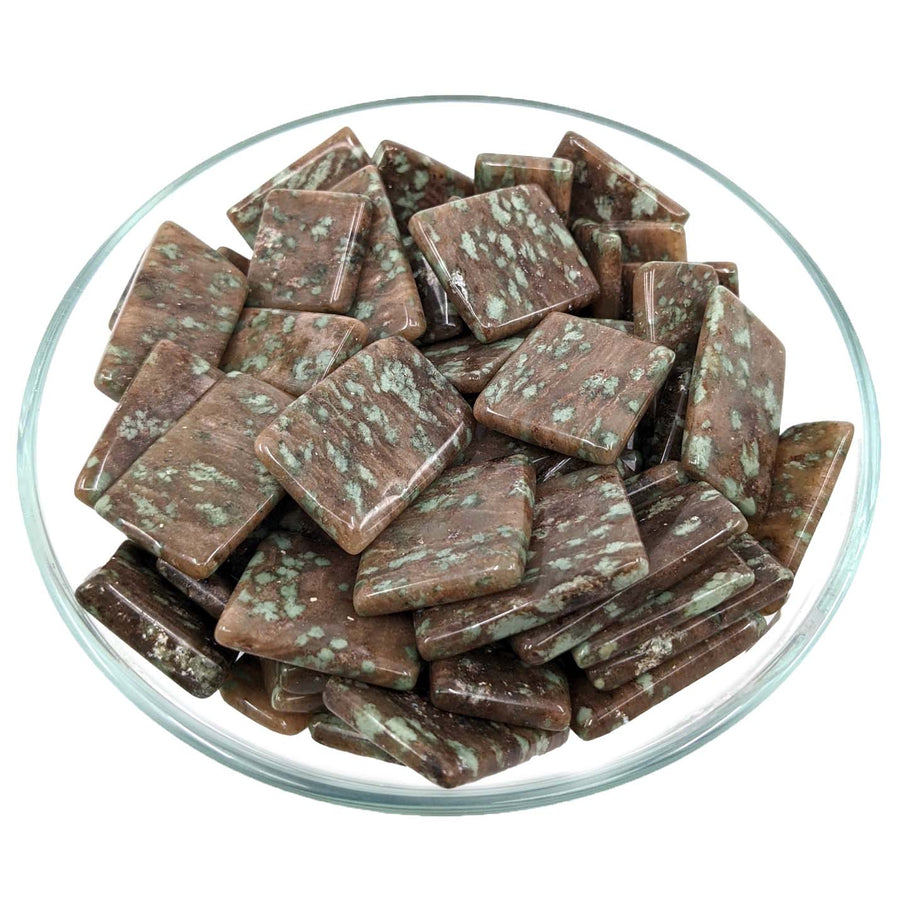 Chocolate squares with mint flecks in glass dish for referral history rewards