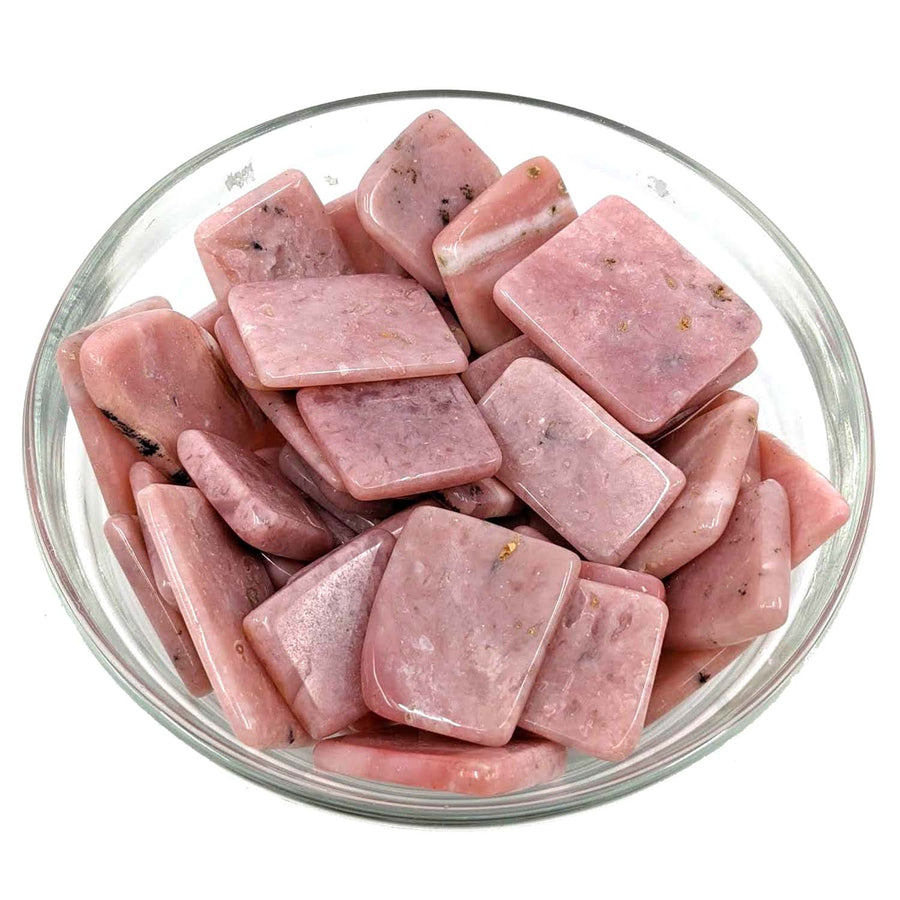 Bowl of raw pork pieces next to Pink Opal Polished Slice for unique cooking use