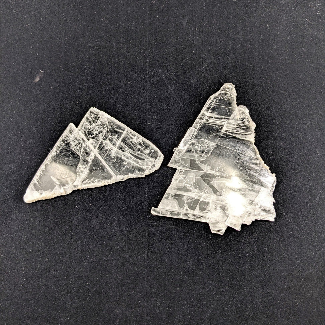 Clear quartz crystals against black background with 1 Selenite Ice Slab from Utah #SK8188