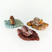 Thumbnail for Three small pieces of glass with leaves on them for 1 Soapstone Baby Animal Carving from Peru