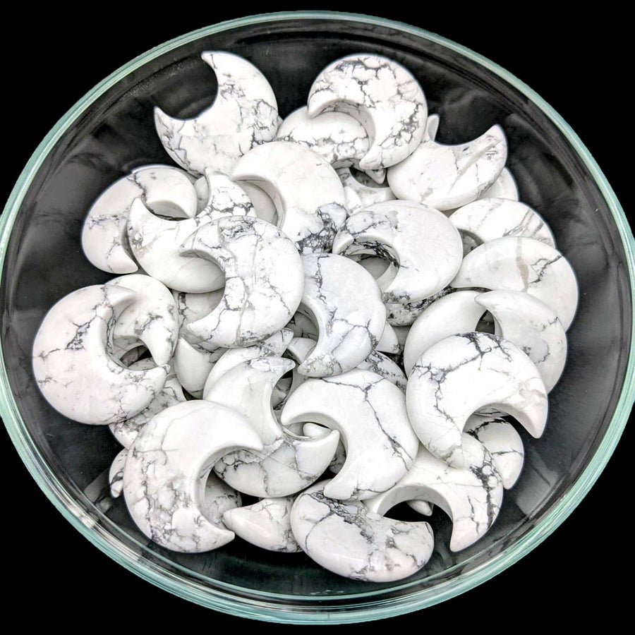 White Howlite crescent-shaped cookies with crackled surfaces in a decorative bowl