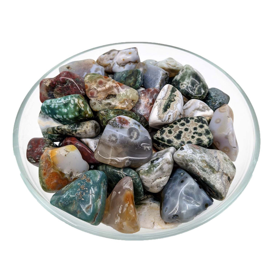 Polished Ocean Jasper tumbled stones in a glass bowl for decorative use and crystal healing