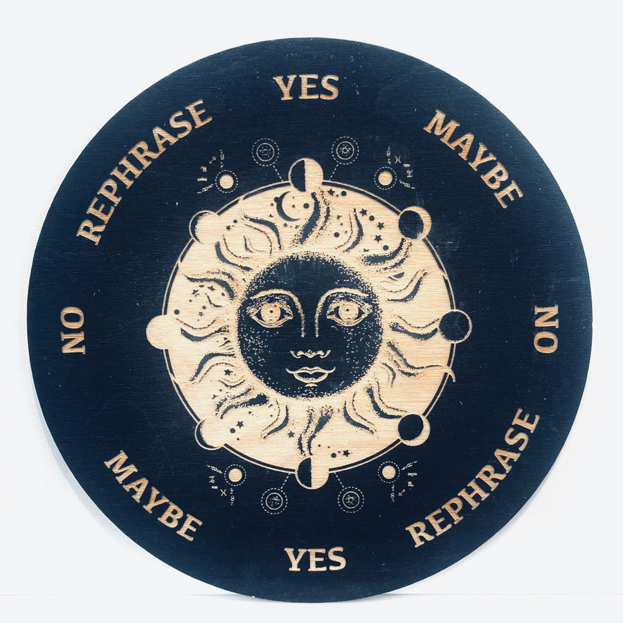 Black and white circular sign with sun and moon on an 8’ Sun + Moon Pendulum Board - Black Wood Grid