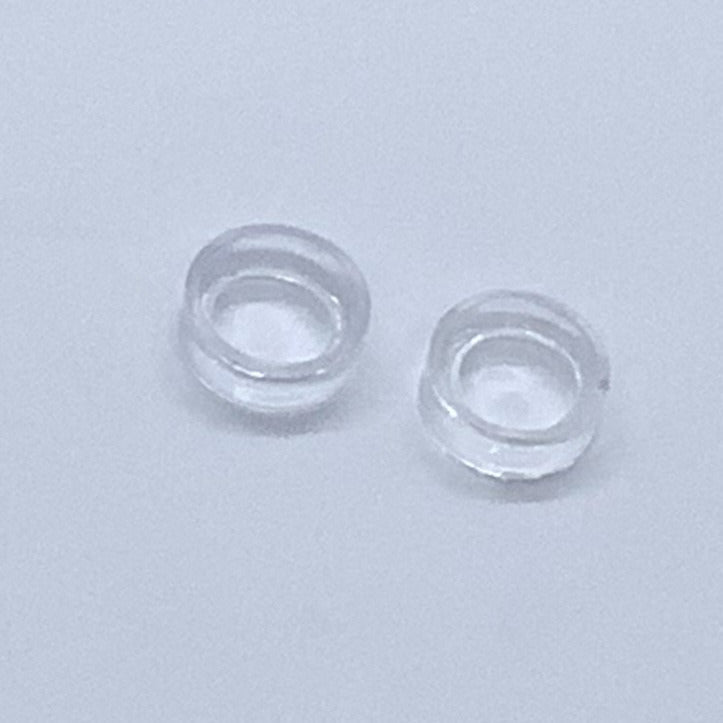 Two clear contact lenses displayed on an Acrylic & Metal Deep Easel Stand #Q152