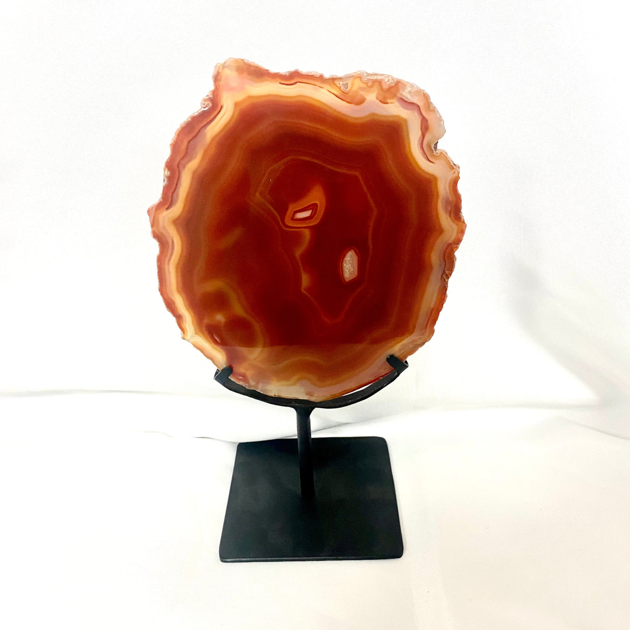 Flat shape Arafed Agate Slice on black metal stand, product #M191, white background