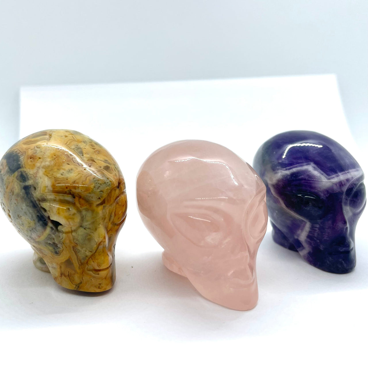 Three colorful crystal skulls in yellow/brown, pink, and purple for Alien Head Carving