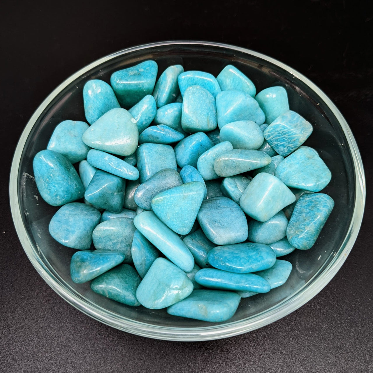 A bowl of Amazonite Dark Med Tumbled Stones (.75 - 1.2’) #LV1276, turquoise colored rocks