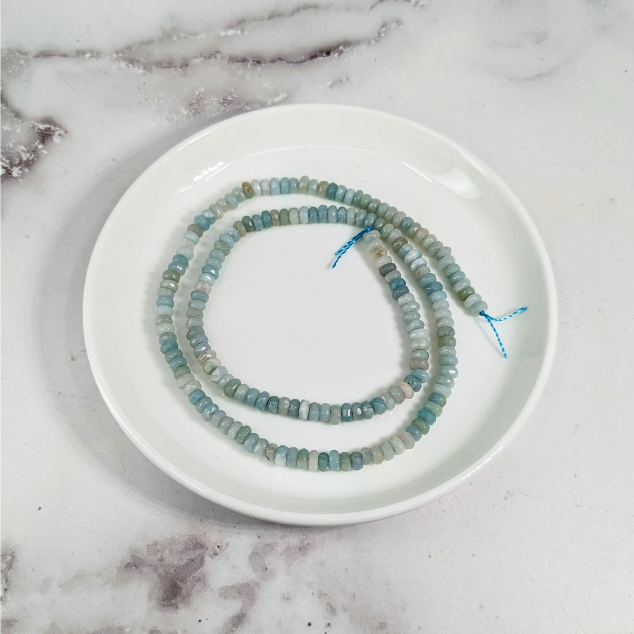 Amazonite Faceted 4 mm Rondelle Bead Strand LV3610 on a white plate