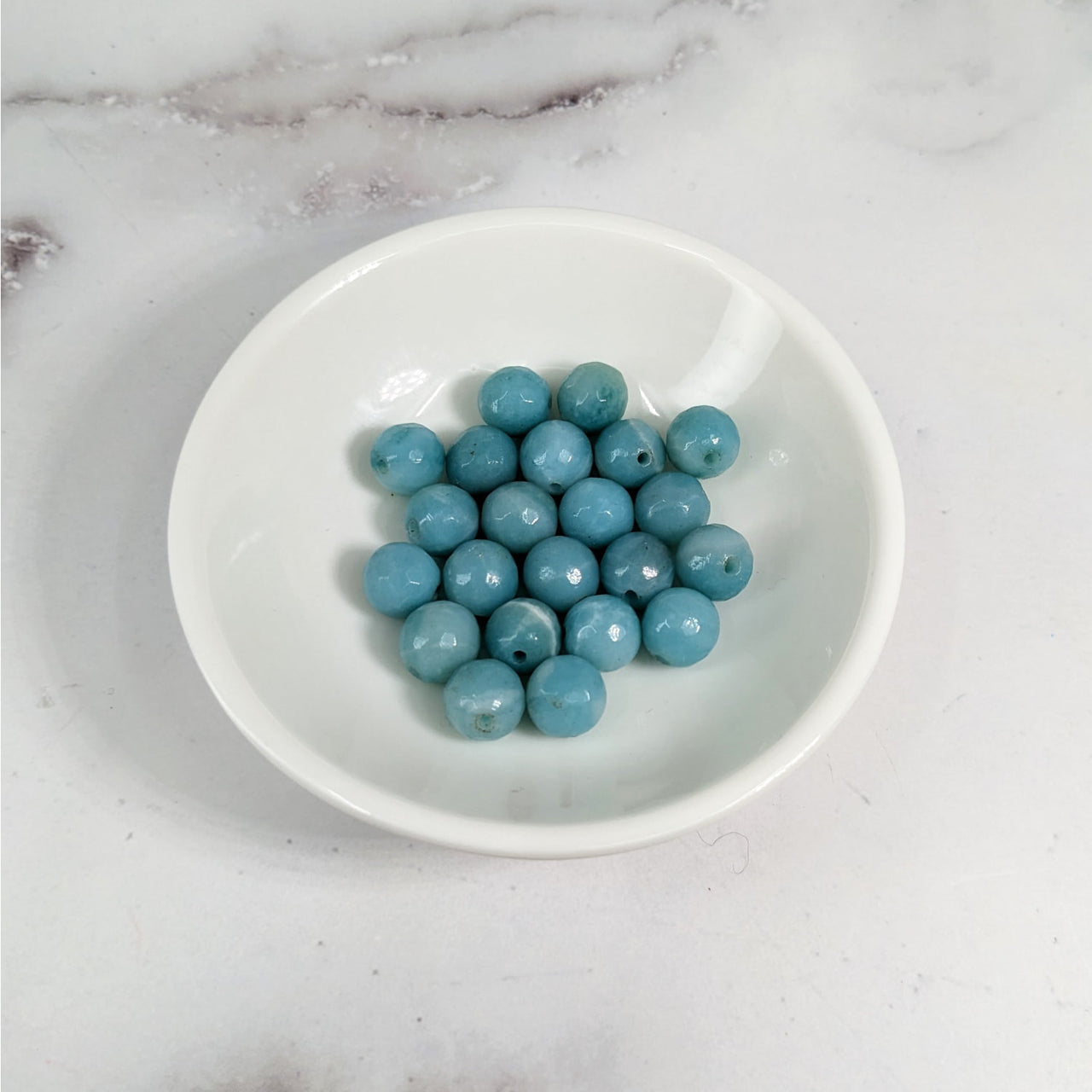 A bowl of blueberries on a marble counter with Amazonite Faceted 8 mm Bead 6 Pack #LV3609