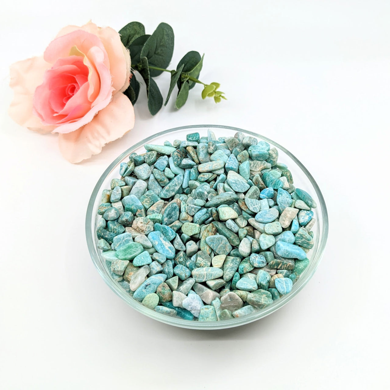 Bowl of amazonite gravel mini chips next to a rose, 28g parcel (.25-.75’) #LV3082