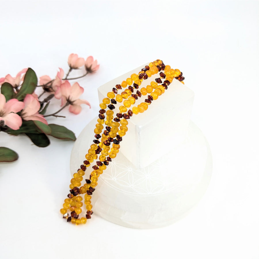 Amber beaded necklace with light and dark beads displayed in the Amber 28 Inch Light w Dark Bead Necklace product