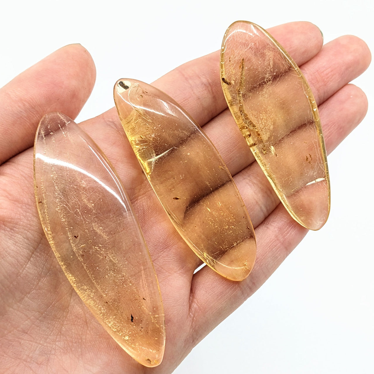 Two large oval gold glass beads, Amber Copal w/ insect inclusions, polished, product #LV1870