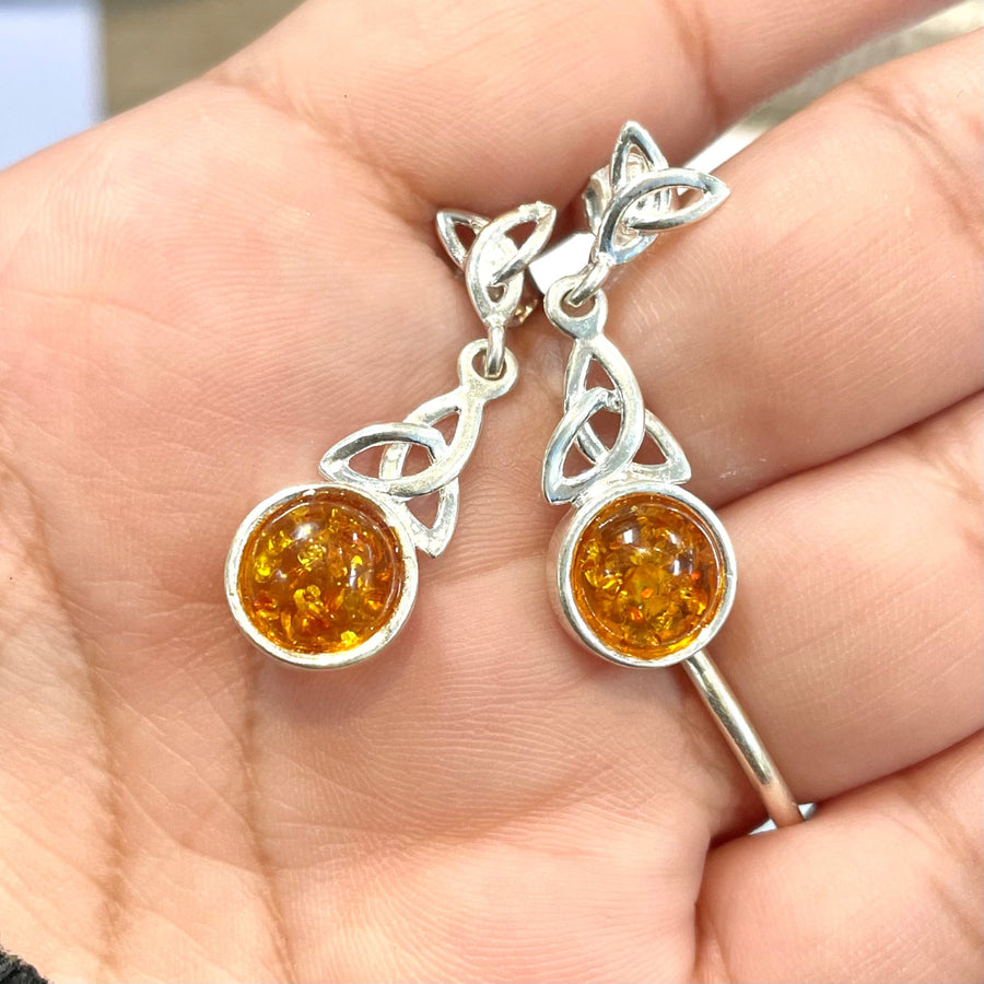 Celtic silver earrings with amber stones and trinity symbol design for reward notifications