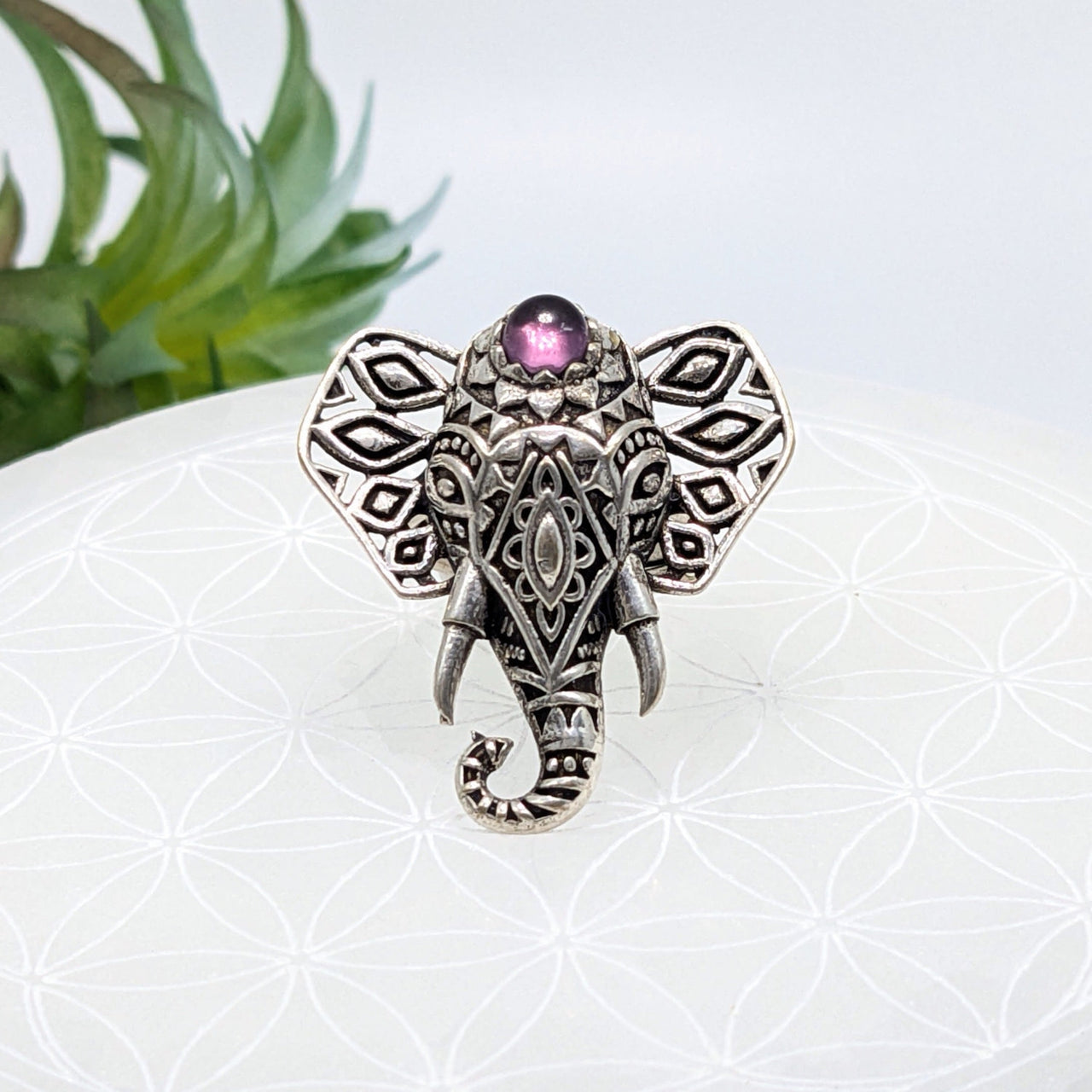 Ornate silver elephant adj 6-9 ring with intricate patterns and pink gemstone