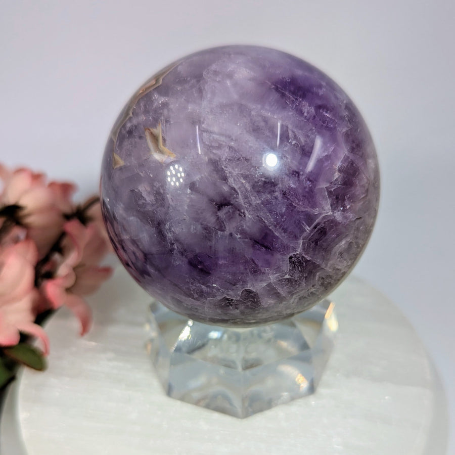 Polished purple amethyst sphere 2.65in with banding on glass stand #BC0167