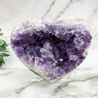 Thumbnail for Close-up of Heart-Shaped Amethyst 4.2’ Geode Heart #LV4632 with Plant Background