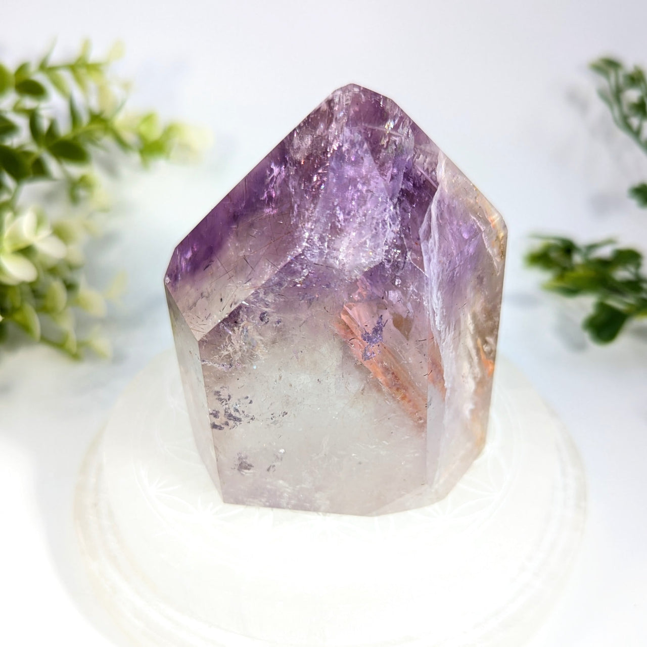 Amethyst 5.4 inch generator with translucent purple crystal, pointed geometric top, and natural inclusions
