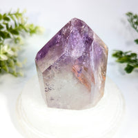 Amethyst 5.4 inch generator with translucent purple crystal, pointed geometric top, and natural inclusions
