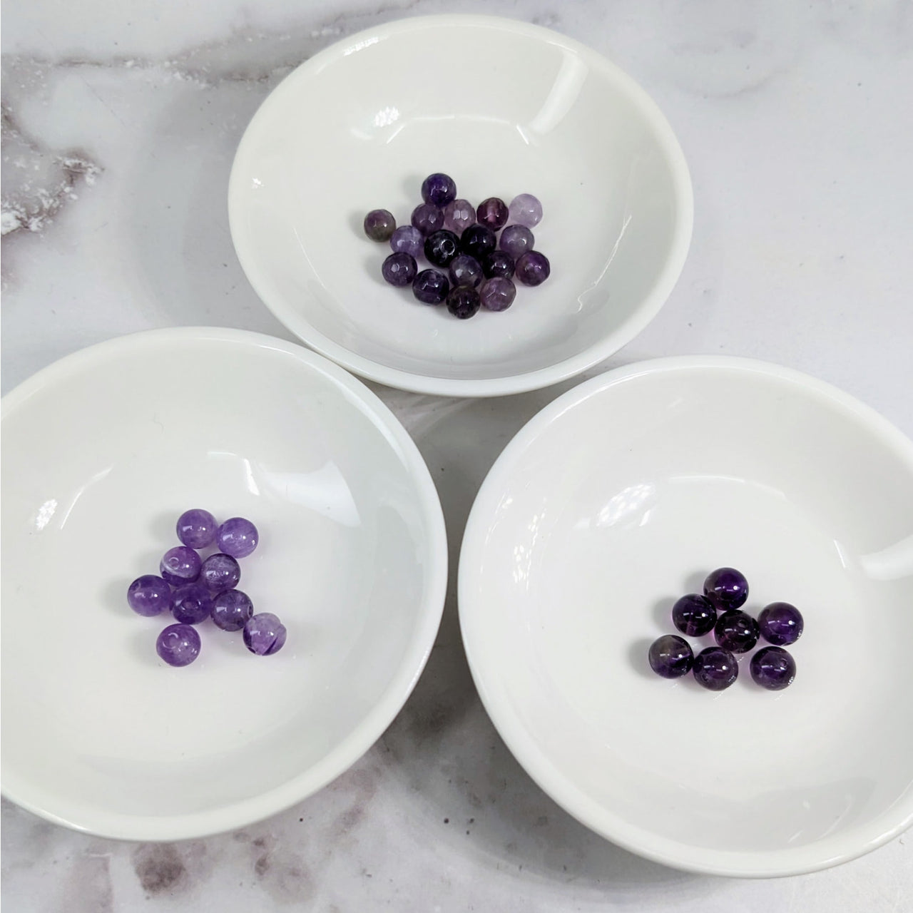 Amethyst 6 mm Assorted Bead Pack #LV3617: Three white bowls filled with purple grapes