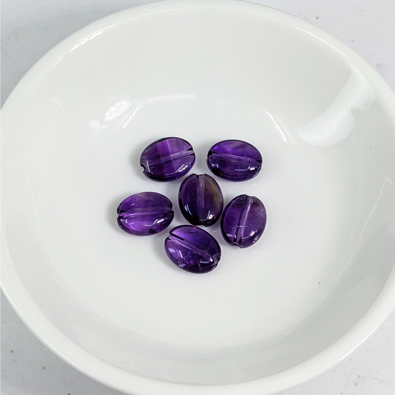 Amethyst 8 mm Flat Bead set on a white plate - 6 pack #LV3618