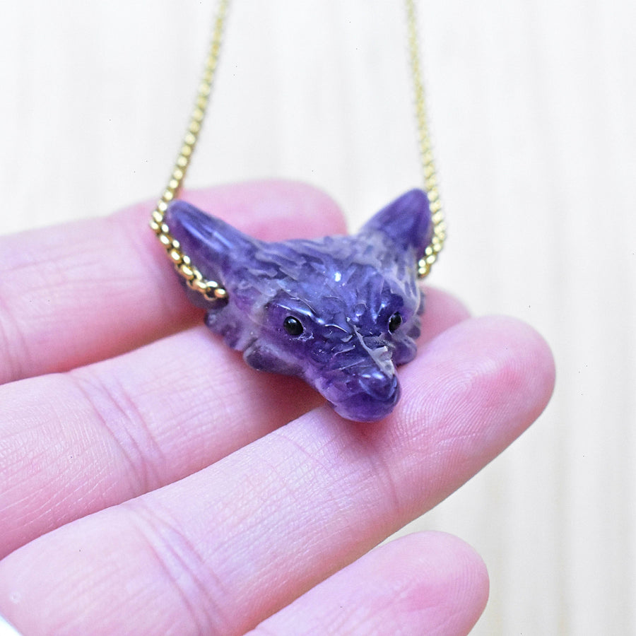 Carved purple amethyst fox head pendant with black eyes on gold chain