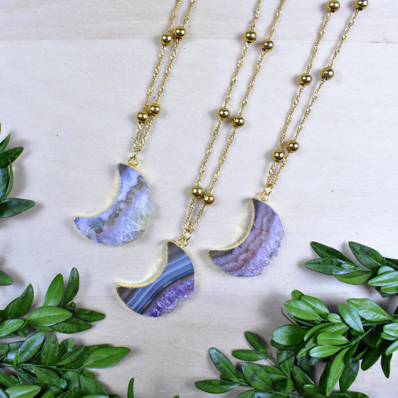 Three gold Amethyst Crescent Moon Slice 18’’ necklaces with purple-blue agate pendants
