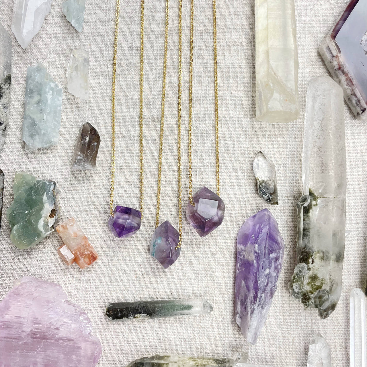 Three delicate gold chain necklaces with unique amethyst double terminated point pendants LV9093