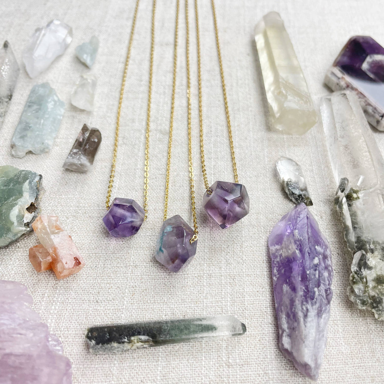 Three gold chain necklaces with faceted amethyst pendants LV9093