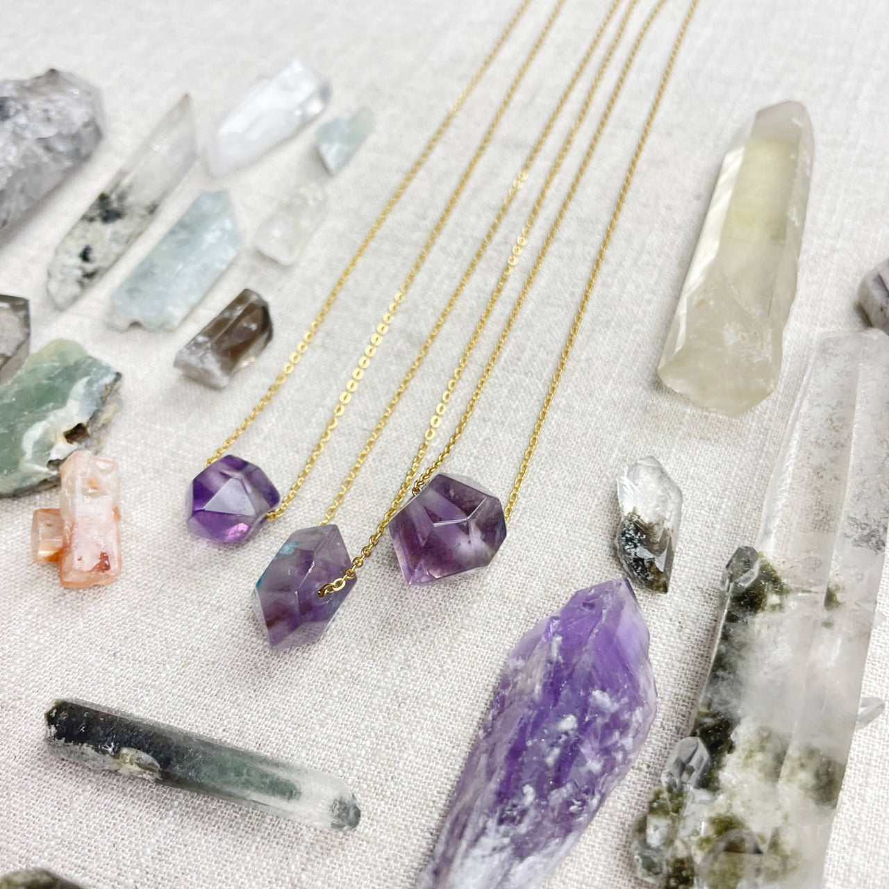 Three faceted purple amethyst pendants on gold chain necklaces LV9093