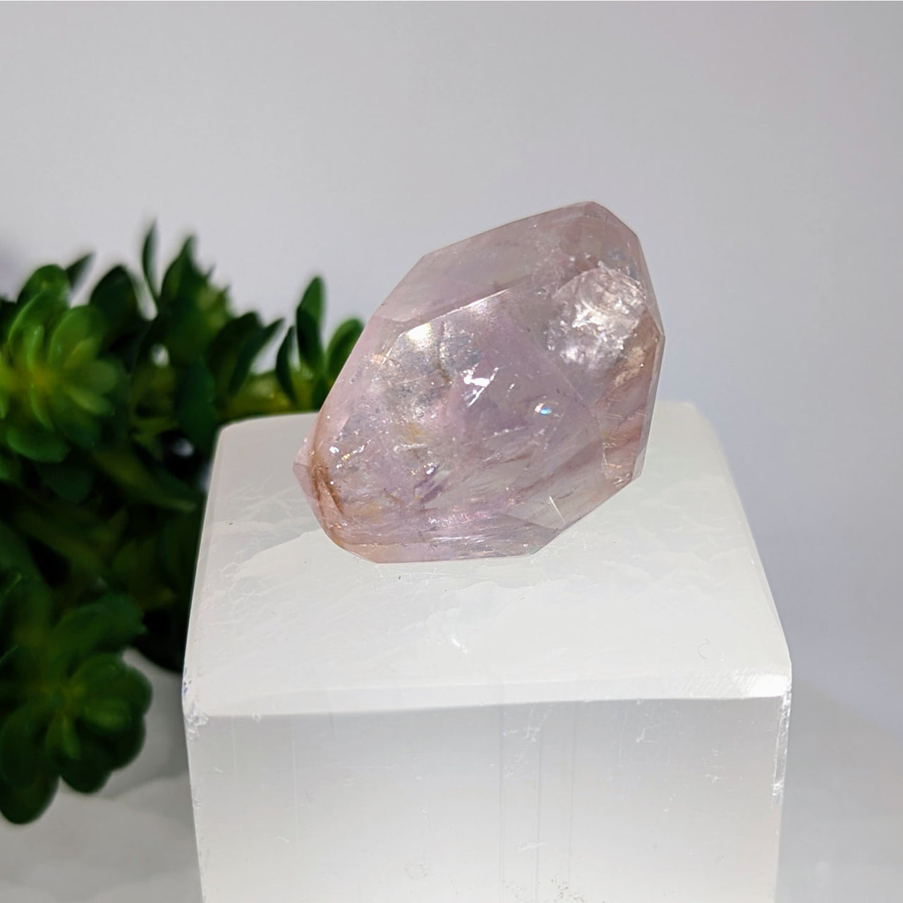 Translucent pink rose quartz crystal faceted geo freeform on pedestal