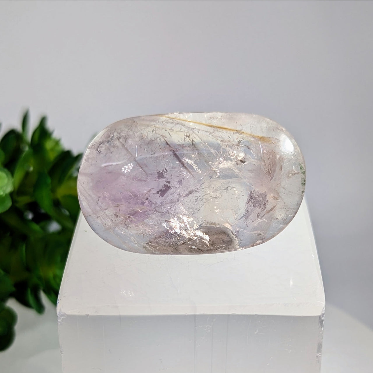Translucent oval amethyst phantom crystal with purple veining, 1.7’’ UV palmstone