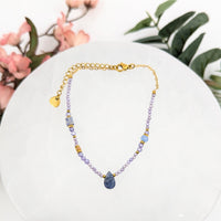 Beaded necklace with teardrop pendant featuring Amethyst and Sodalite stones