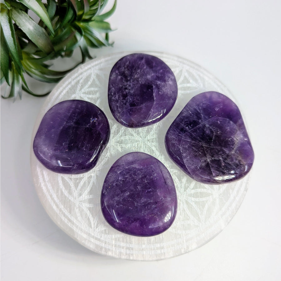 Four polished Amethyst Zambia stones measuring 1.6-2 inches in the Palm #LV7686 display