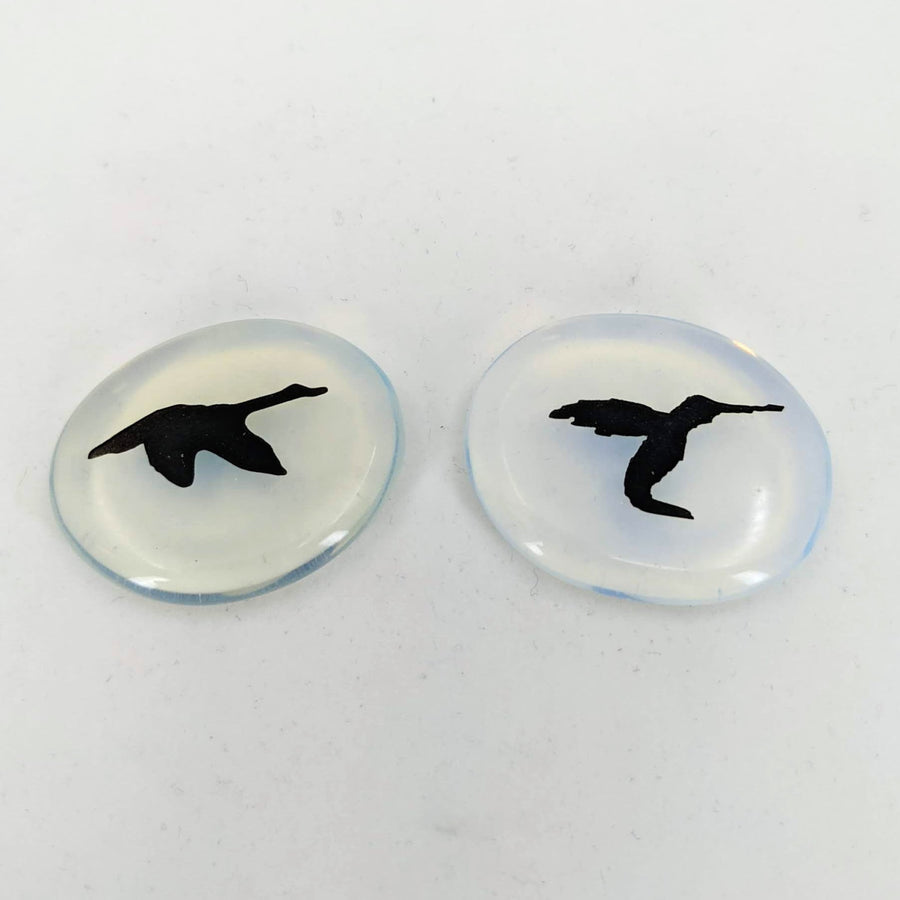 Pair of intricate bird engravings on Animal Palm Stone #T389D against a white backdrop