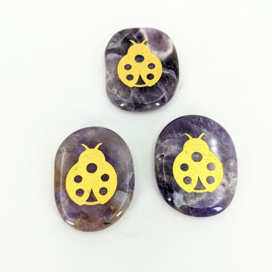 Purple and Gold Skull Cabs on White Background - Animal Palm Stone #T389D