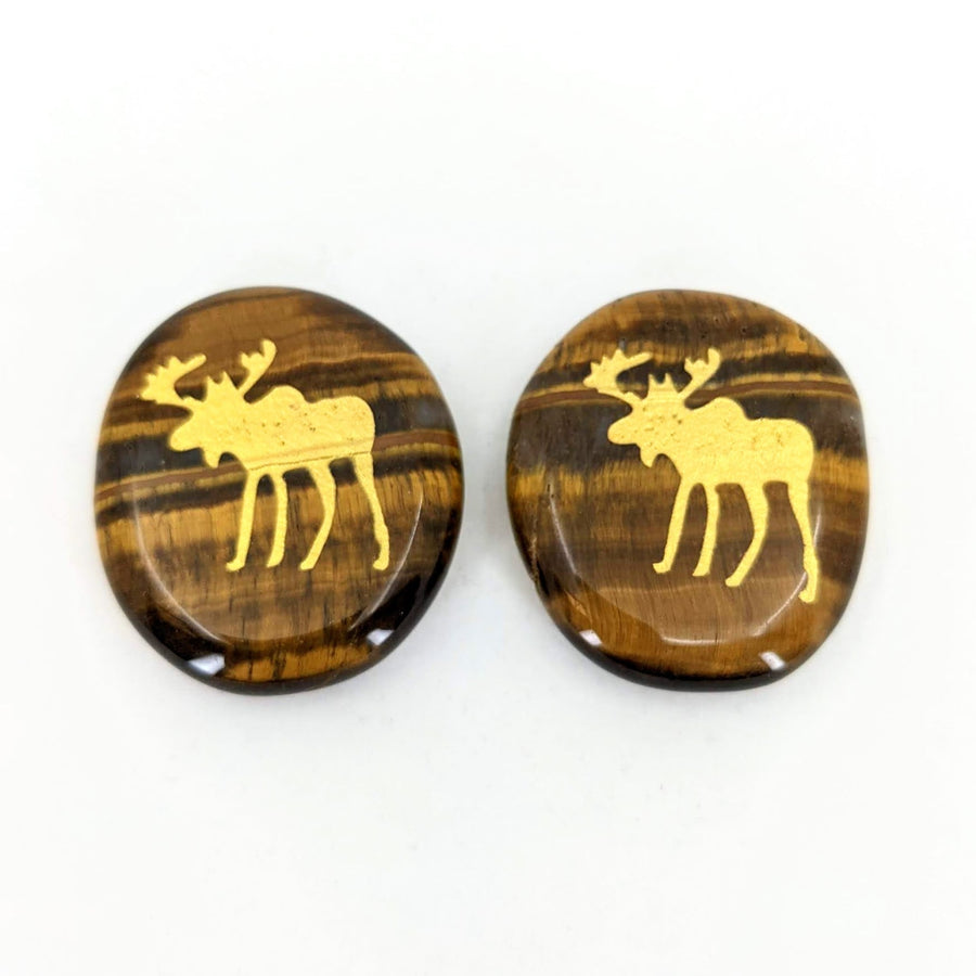 Wooden buttons with a moose design from Animal Palm Stone #T389D on a white surface