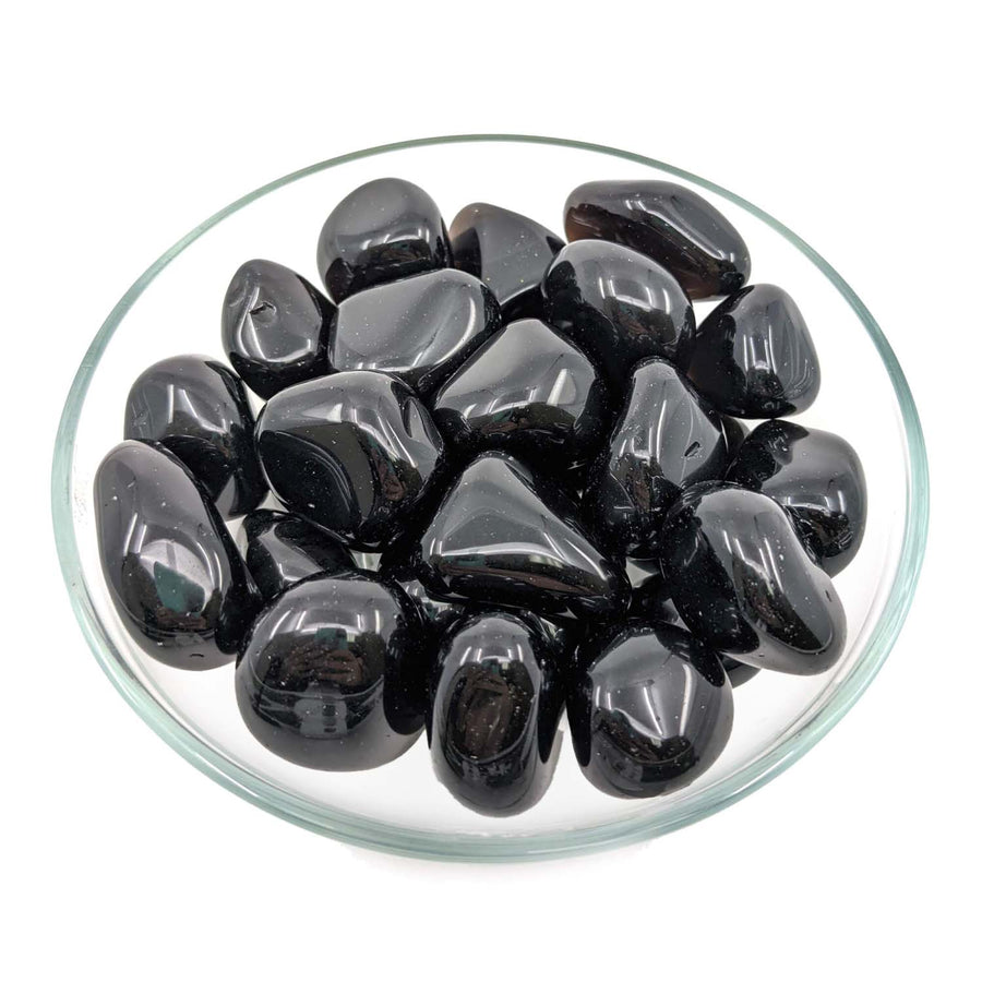 Polished black Apache Tears tumbled stones in a glass dish showcasing #SK6312