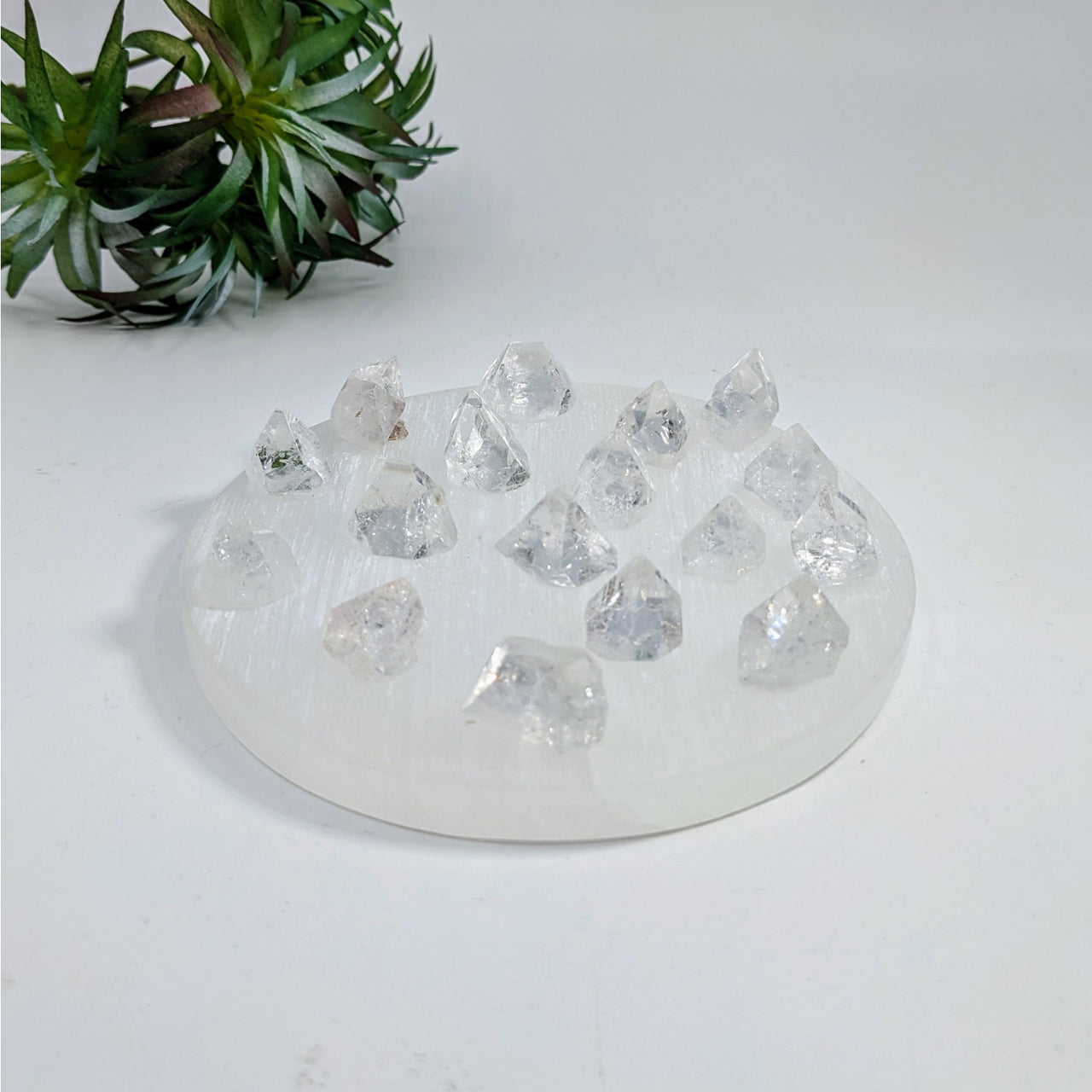 White circular base with clear crystal formations for Apophyllite Tip C026 item tier benefits