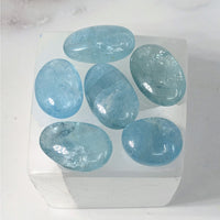 Thumbnail for Aquamarine A+ Polished Stone #LV3887: Five Blue Stones in a White Box on a Table