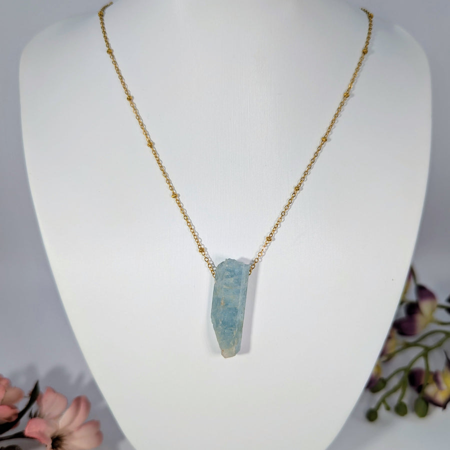 Gold beaded chain necklace with light blue crystal pendant from Aquamarine Rough collection