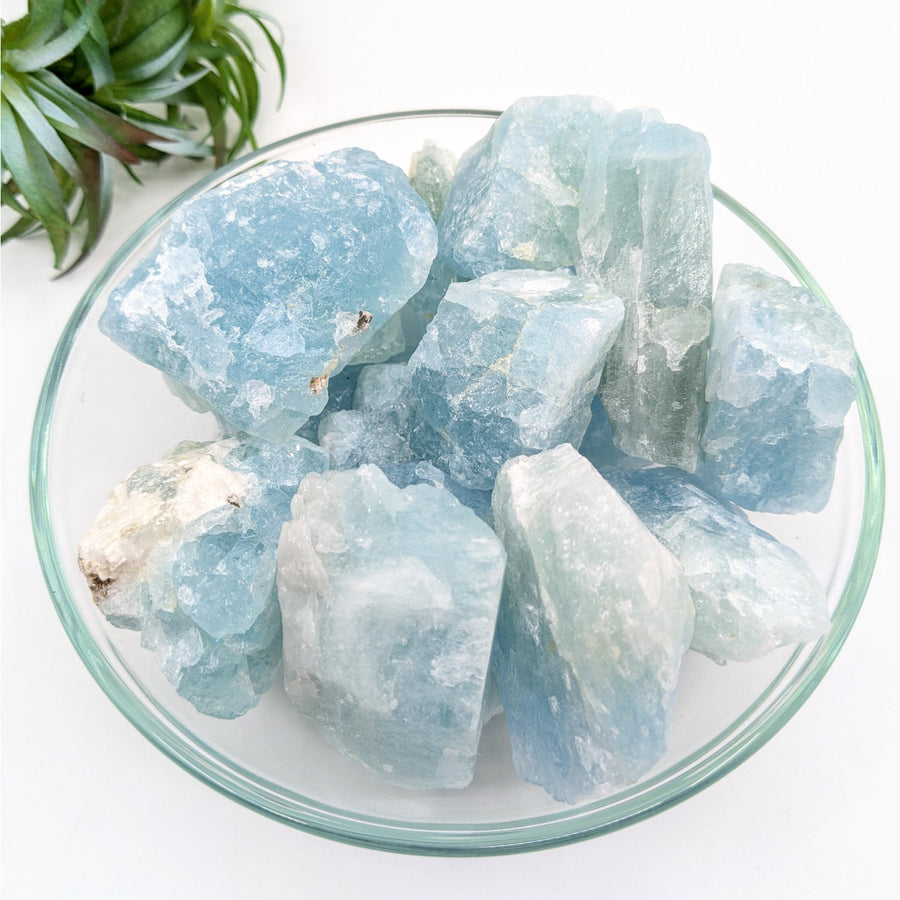 Bowl of rough aquamarine stones showcasing natural aquamarine rough stone for jewelry or collection