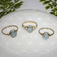 Three delicate gold aquamarine oval rings, bezel set, size #BC0392